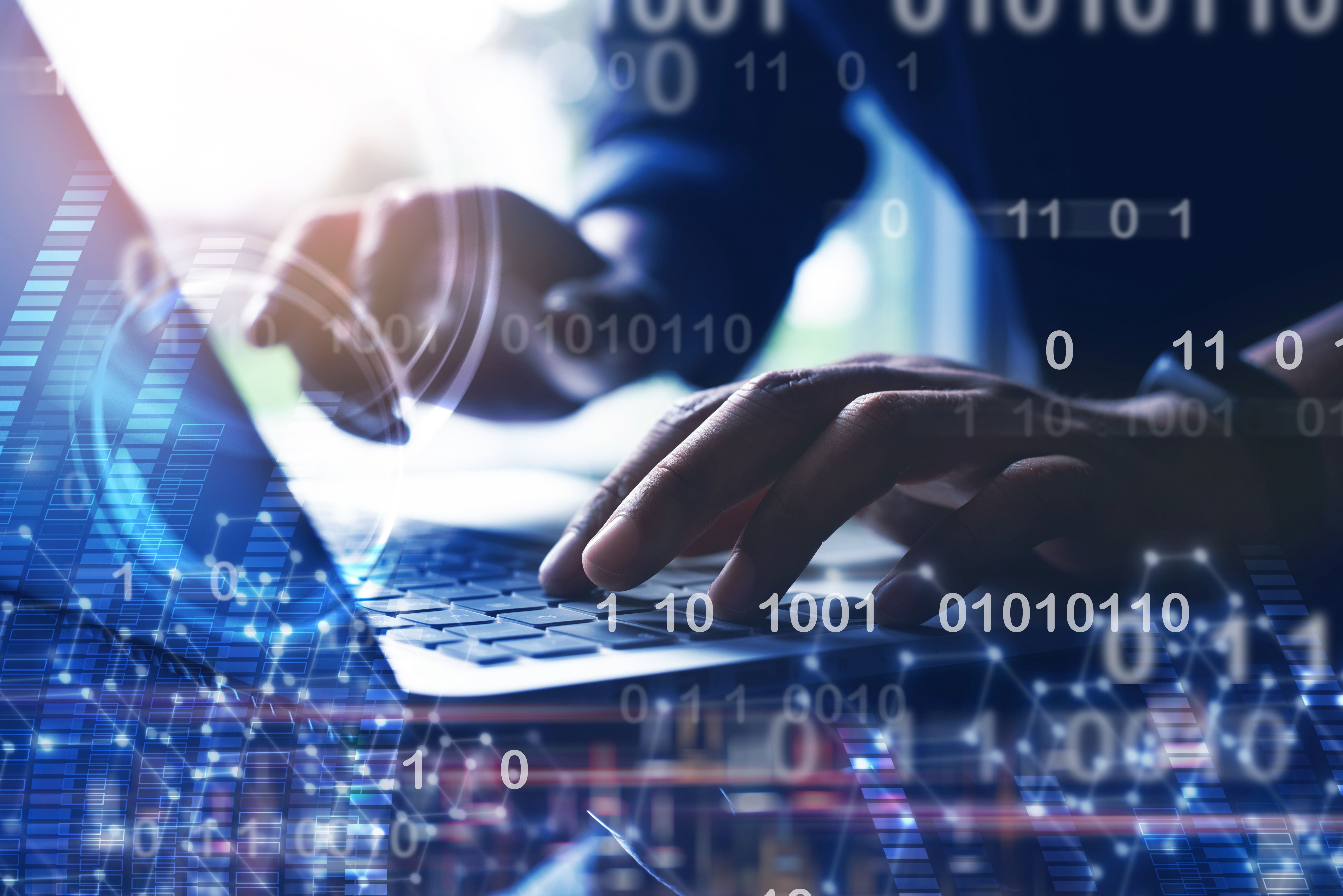 Hands typing on a laptop. Overlaid are digital image elements such as binary code and abstract graphics.
