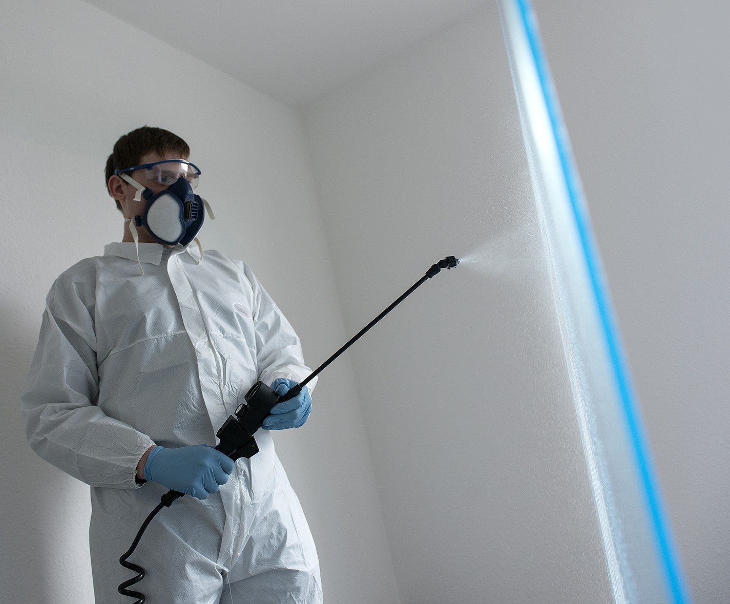 Man spraying chemicals.