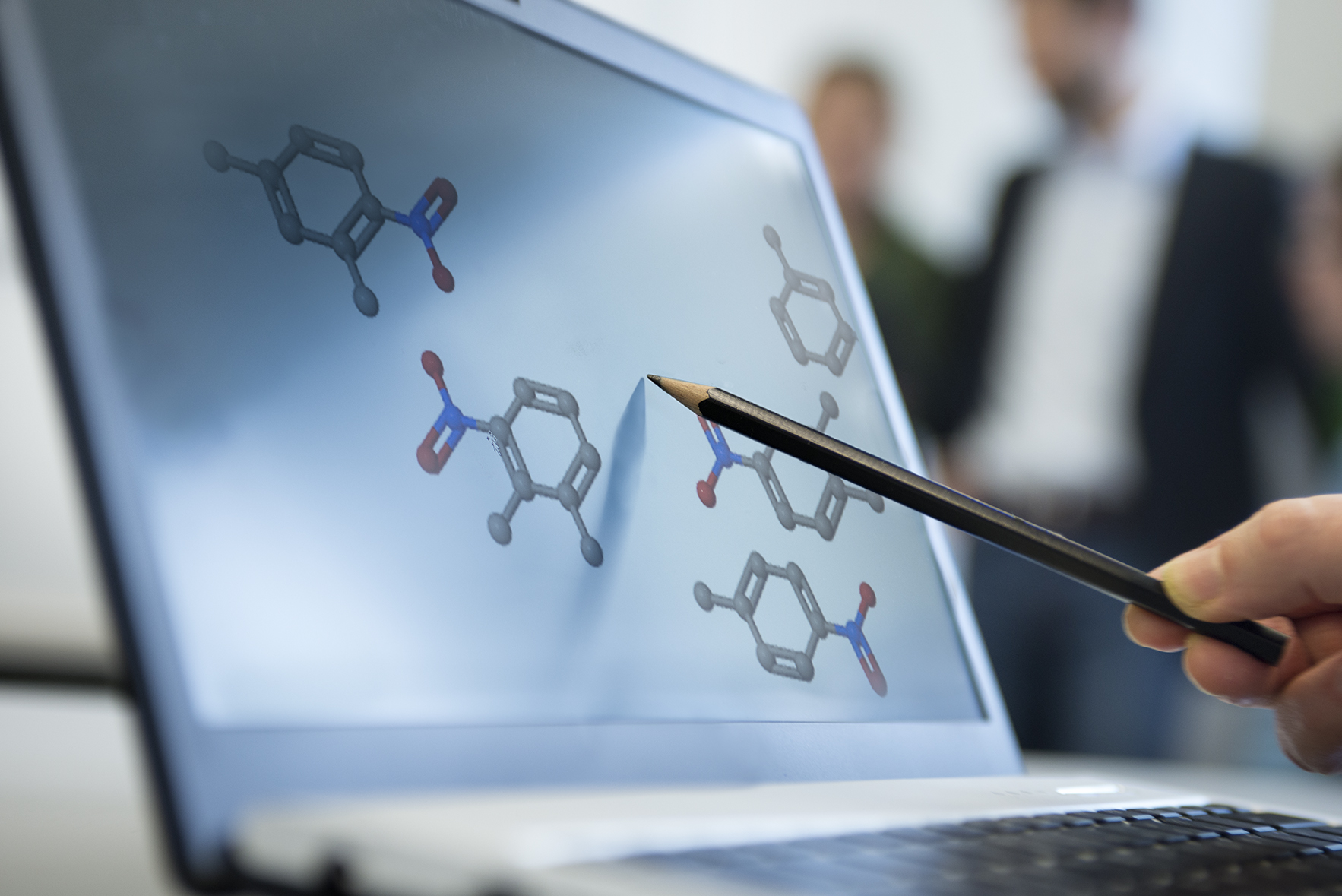 Graphics of molecules displayed on a laptop.